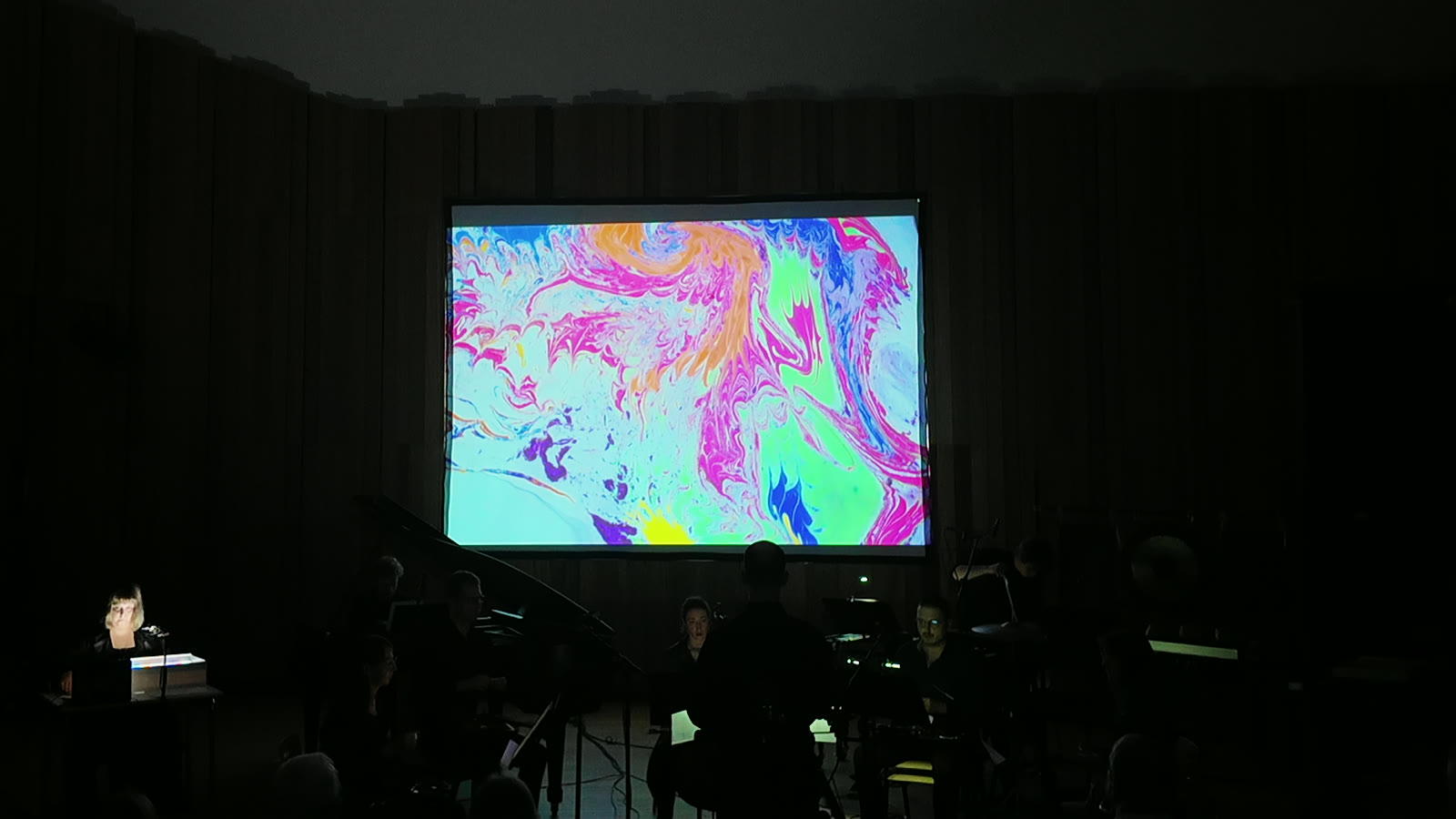 a fully worked marbled surface, pink, orange and turquoise, above the ensemble